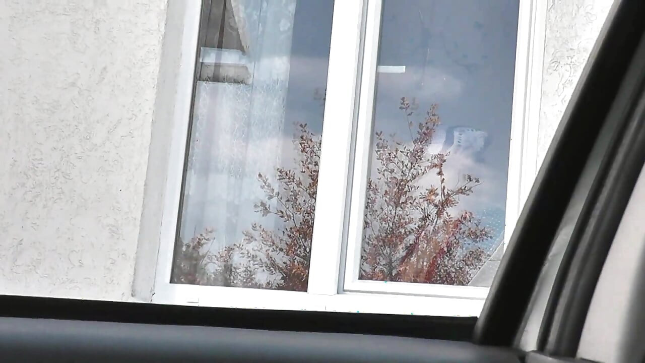 Naked in public. Taxi driver watches from car as woman in robe without panties and bra in stockings washes an apartment window
