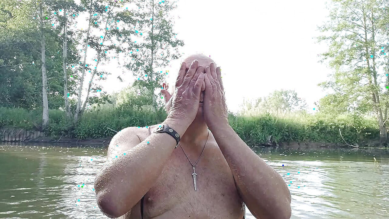 The plump, mustachioed daddy is having a blast in the stream, shamelessly masturbating with mud