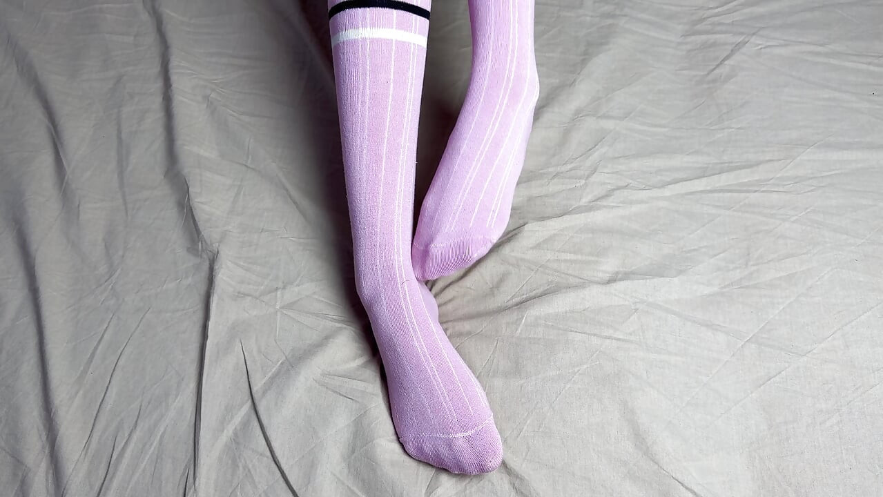Pink socks in hands of mistress with blue nails in solo video