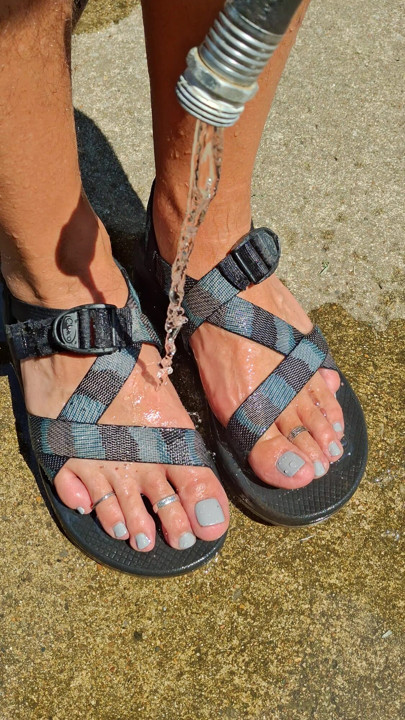 Cleaning off my pedicured feet and dirty sandals after a long hike