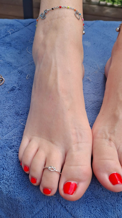 Cute little size 7 US feet teasing me with red nail polish, toe rings and anklets.
