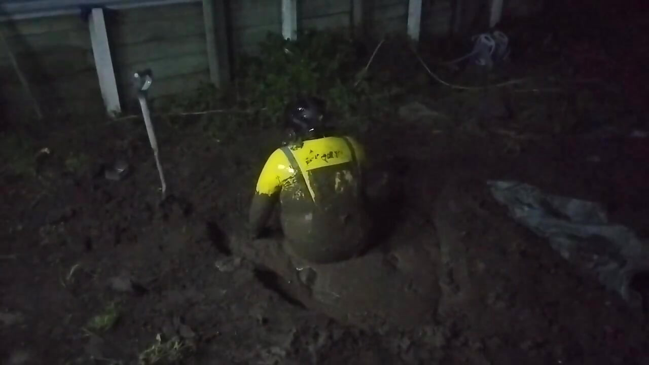Latex Biohazard Drone Plays in Mud Pit