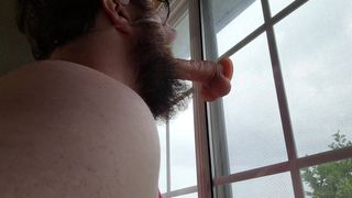 Exposed sissy pig in window sucking dildo