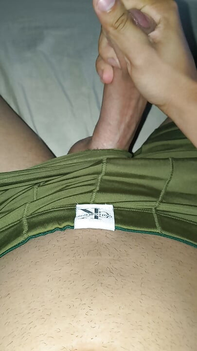 Young man taking off his green underwear getting naked masturbating big and thick cock