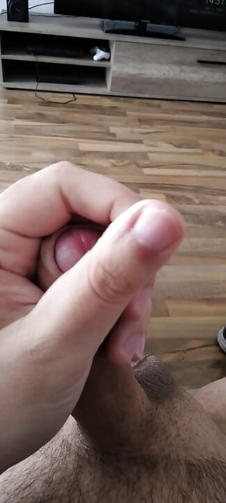 Horny young man massages his cock and cums lustfully