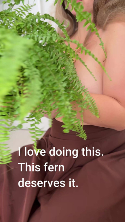 My wife looks wonderful with her bare breasts next to her fern.