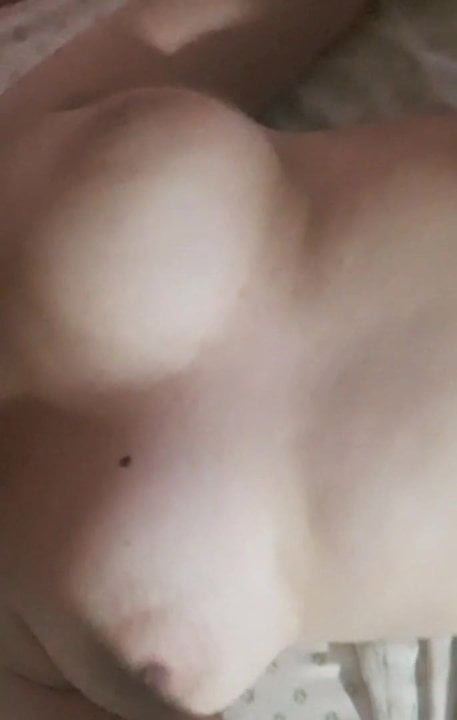 Dancing tits while lying in bed