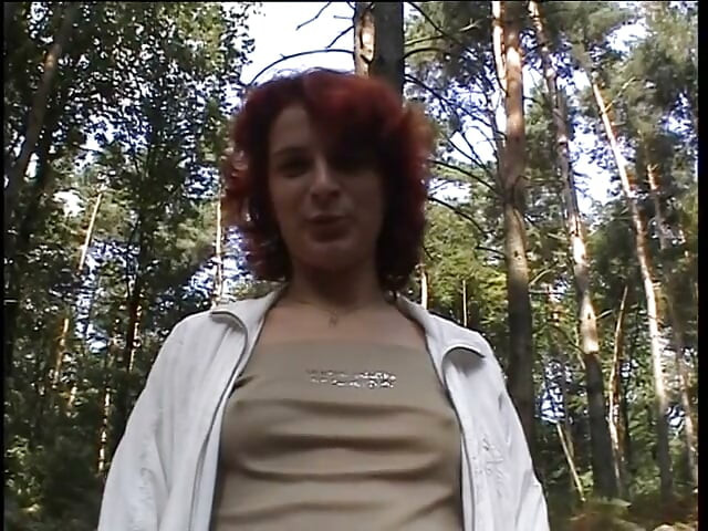 Redhead chick plays with her pussy outdoors