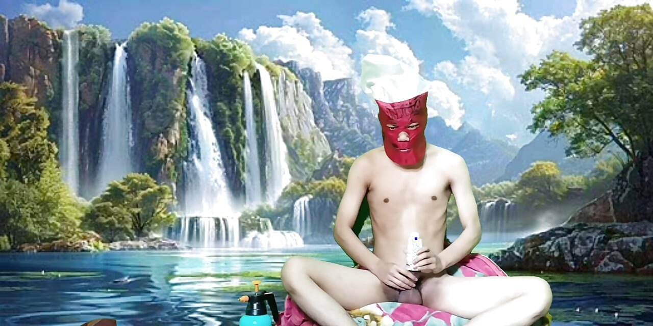 Masturbating with a dildo made from a bottle, used under a waterfall.