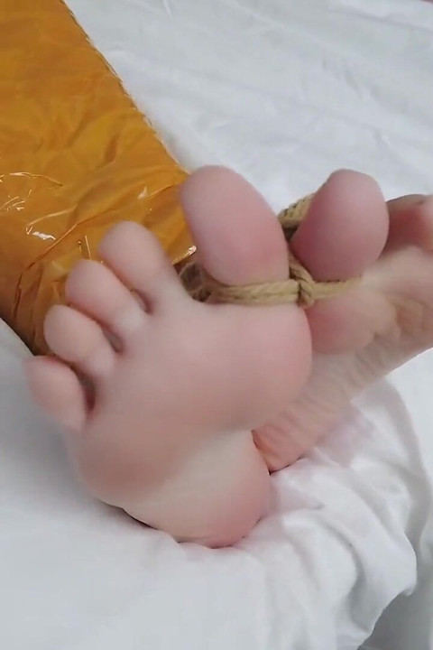 First-person Perspective Records the Girlfriend Wrapped in Tape From Head to Toe with Her Beautiful Bare Feet