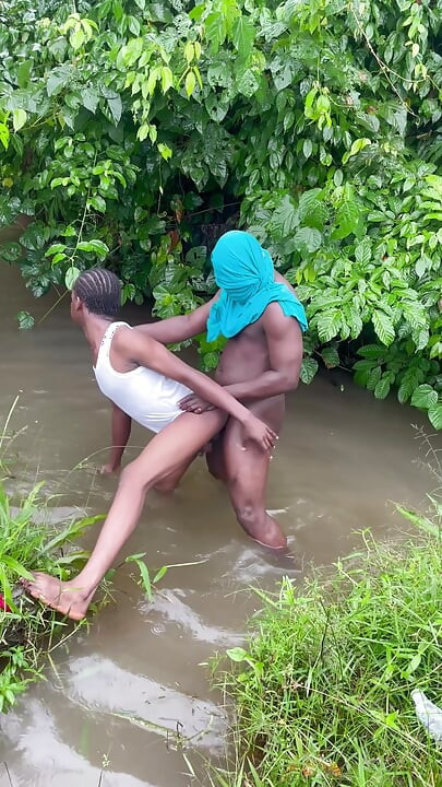 Sex Inside a Swampy River Rounded by Wild Bushes