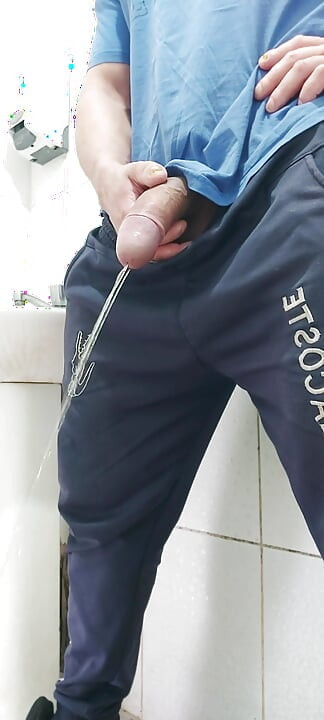 A Well-endowed Brazilian Man Urinating and Showing His Thick Penis to His Female Friends.