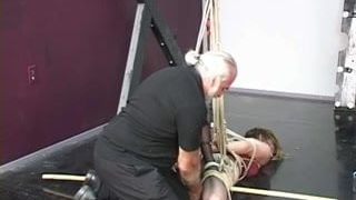Lovely young slave girl in lingerie is restrained in the sex basement by master