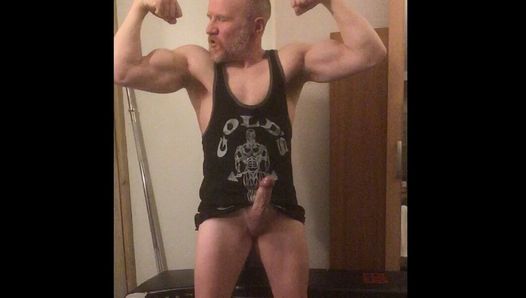 Verbal muscular Bodybuilder Daddy flexing muscles with huge boner in his gym vest shoots a huge load of cum