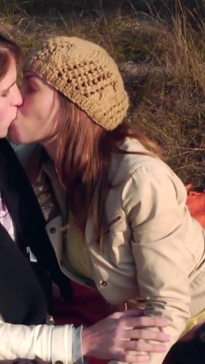 Sharing a gentle kiss outdoors the lesbian couple gets heated and they take out their strapon | Clip 1