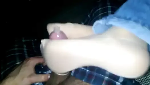 Nylon feet jerking condom covered cock