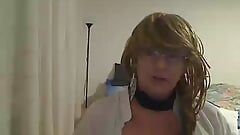 horny MILF tranny showing off and petting on webcam wearing a short dress, white blouse, fishnet stockings and heels