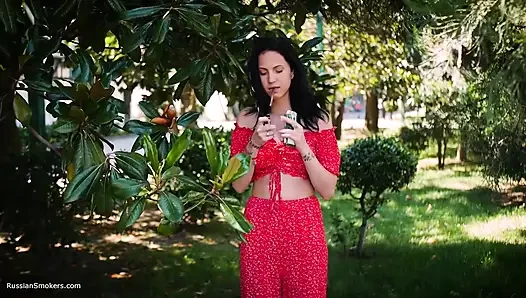 Sultry Brunette in Red Dress Smoking Rolled Cigarette