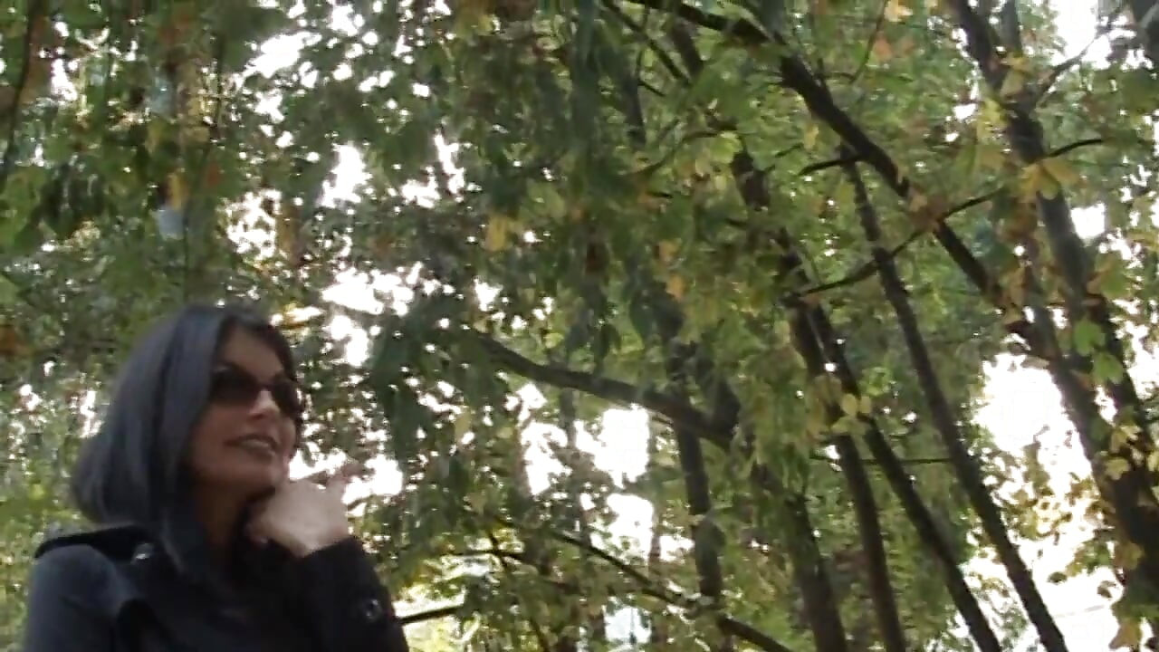 Hot and sexy milf fingers her pussy on the bench of a park