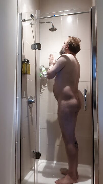 Chastity locked bear takes a ahower