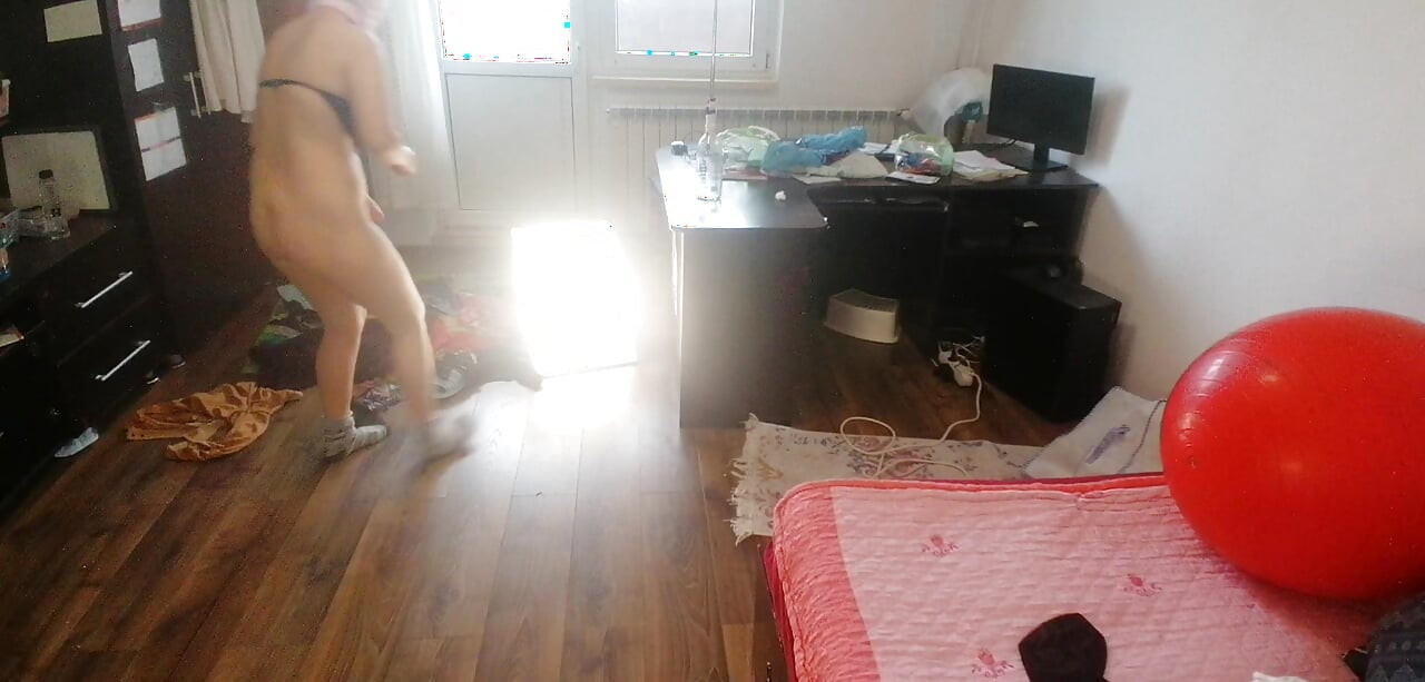 Amateur woman has fun trying on clothes and cutting them.