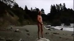 stroking on nude beach, stranger finishes him off