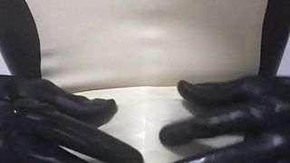 Catsuit handjob wearing latex sheath inside