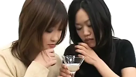 Two sexy Japanese girls spit in a glass and...