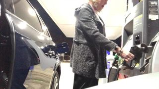 Cold night at the gas station in sexy midi-skirt and boots