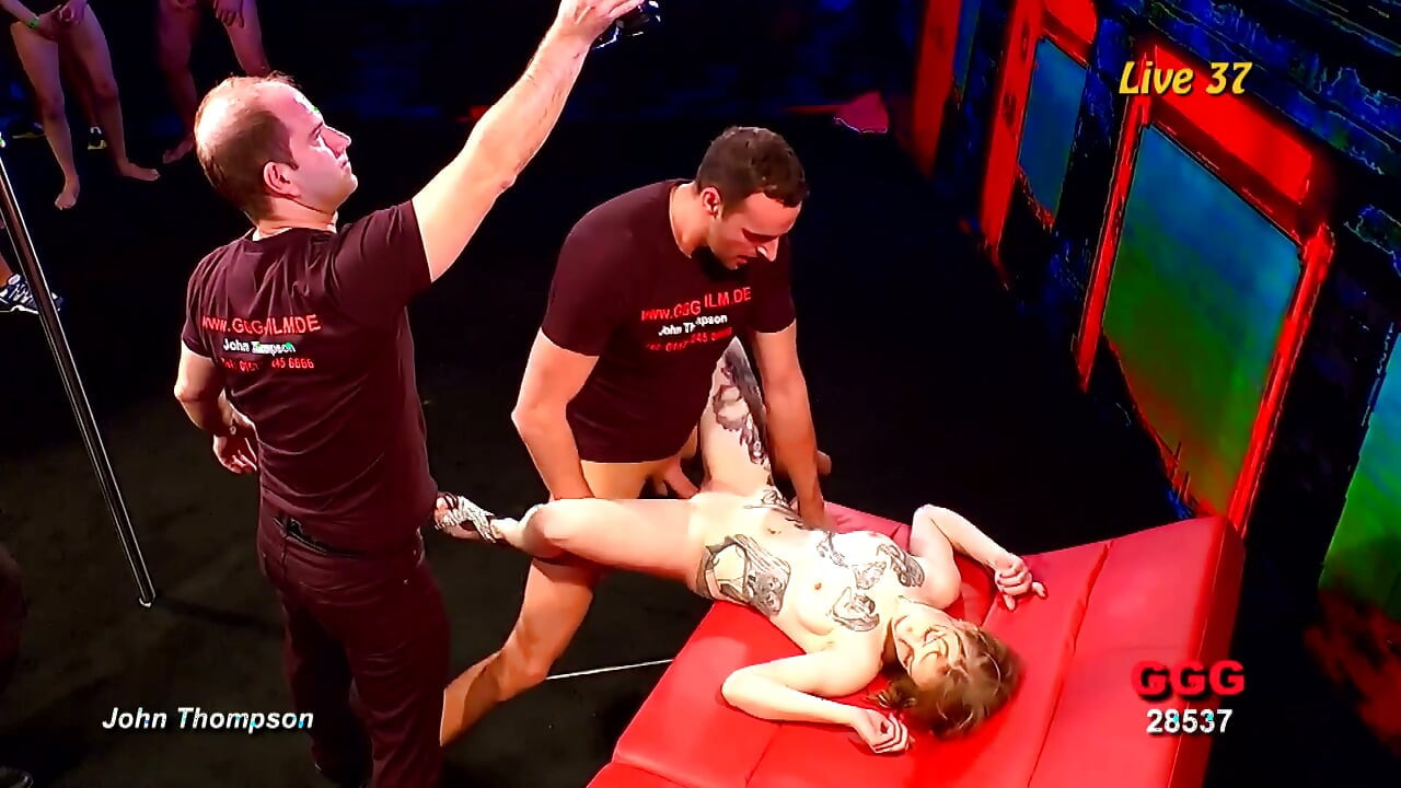 Tattooed Blonde Sucks Multiple Cocks in Live Gangbang and Takes Facial
