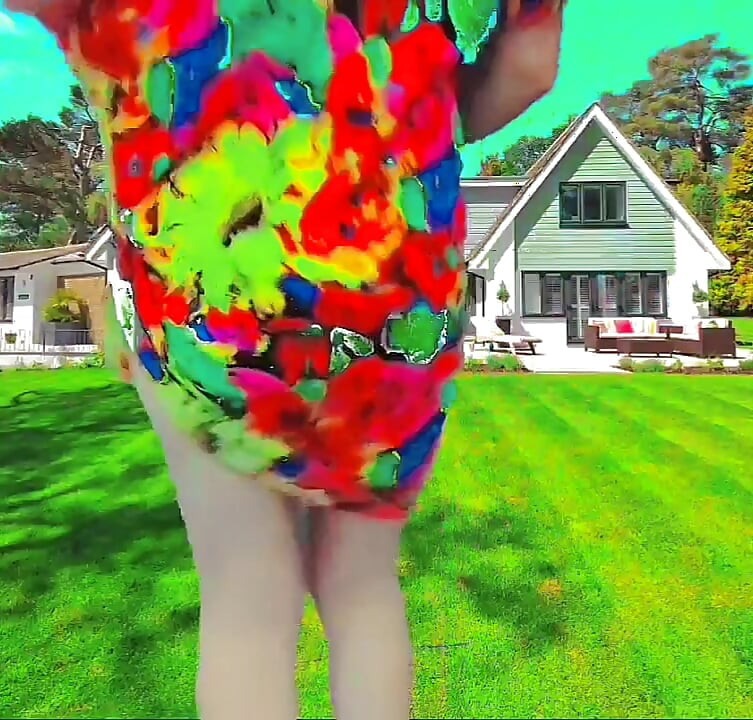 Playful femboy teasing with skirt in windy street
