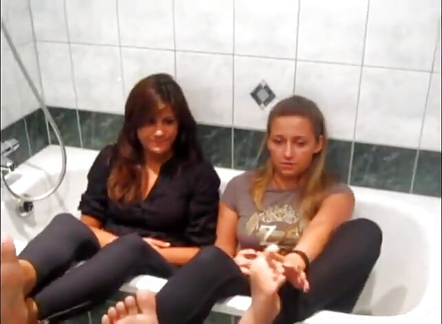 Two sexy teen lesbians in bathroom plays with their feets