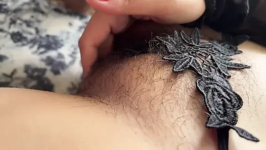I'm filming myself on my phone while I masturbate my hairy pussy.