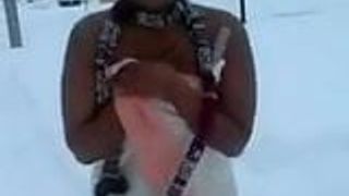 Черная женщина тверкает обнаженной в снегу