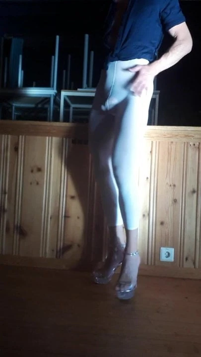 In white leggings and heels