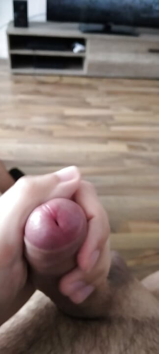 Horny young man massages his cock and cums lustfully