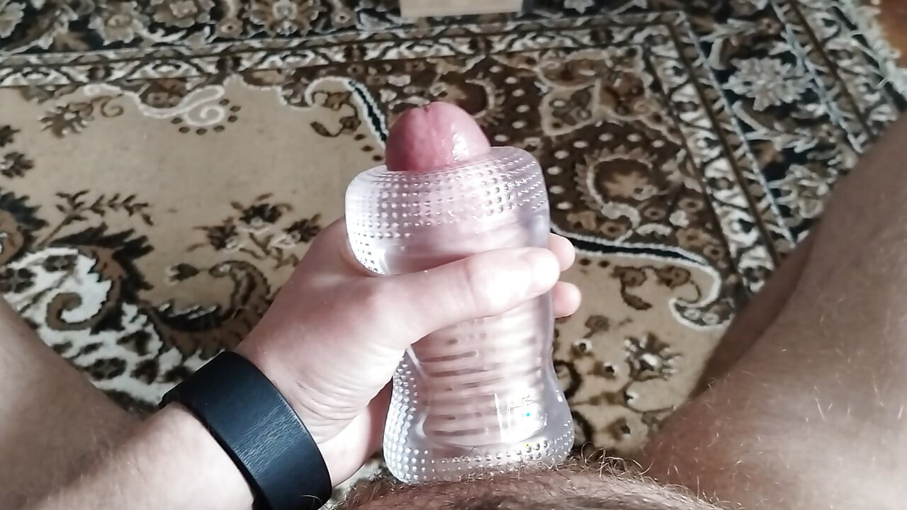 A man masturbates with a sex toy until he cums
