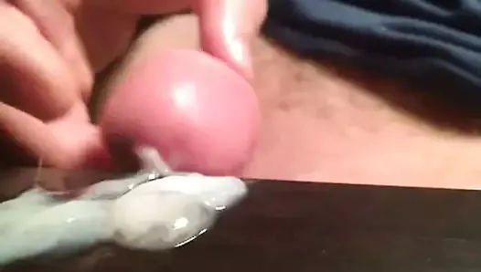 Extreme closeup sticky thick cum flow onto black table