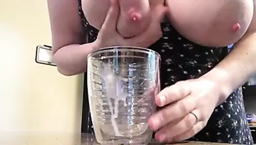 Big tits filling cup with milk