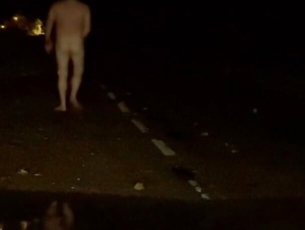 Naked in road and hiding the wrong side of road from safety when car passed