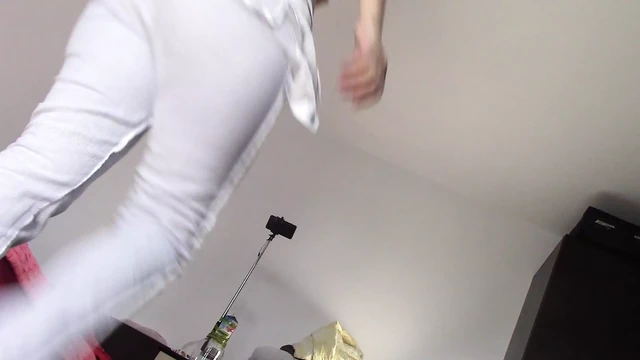 Amateur wife dancing naked at home. Amateur woman has fun trying on clothes and cutting them.