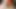 red-haired Asian woman took in her mouth under the table