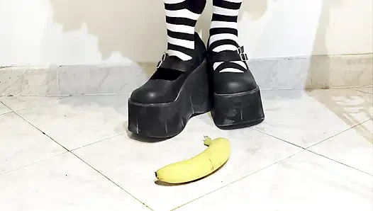 Goth crushing a banana under her shoes