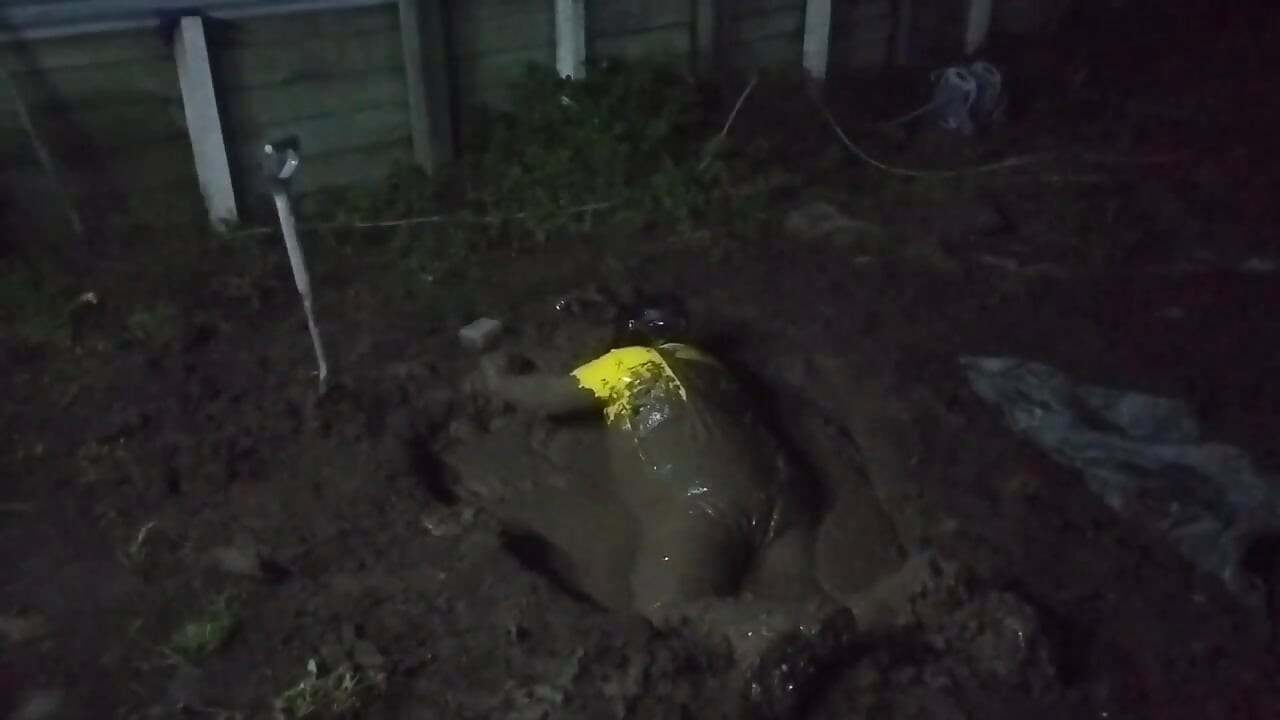 Latex Biohazard Drone Plays in Mud Pit