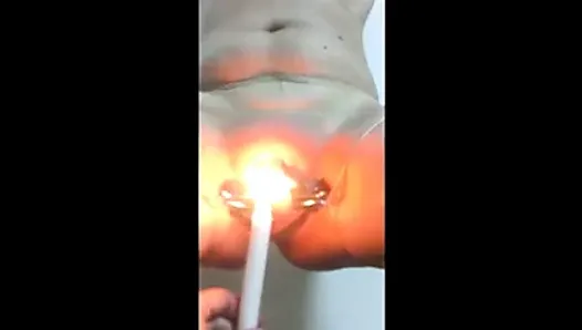 Women playing with candle inside pussy