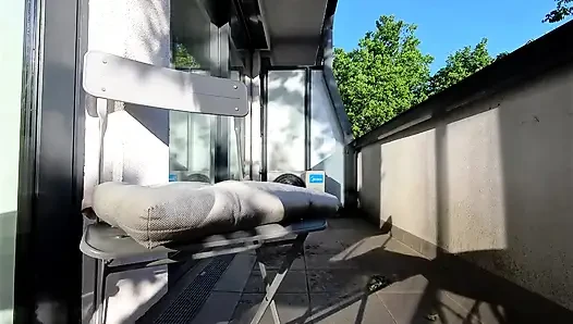 Wonderfully beautiful girl in a summer dress no panties on the balcony shows her tight shaved pussy to the neighbors