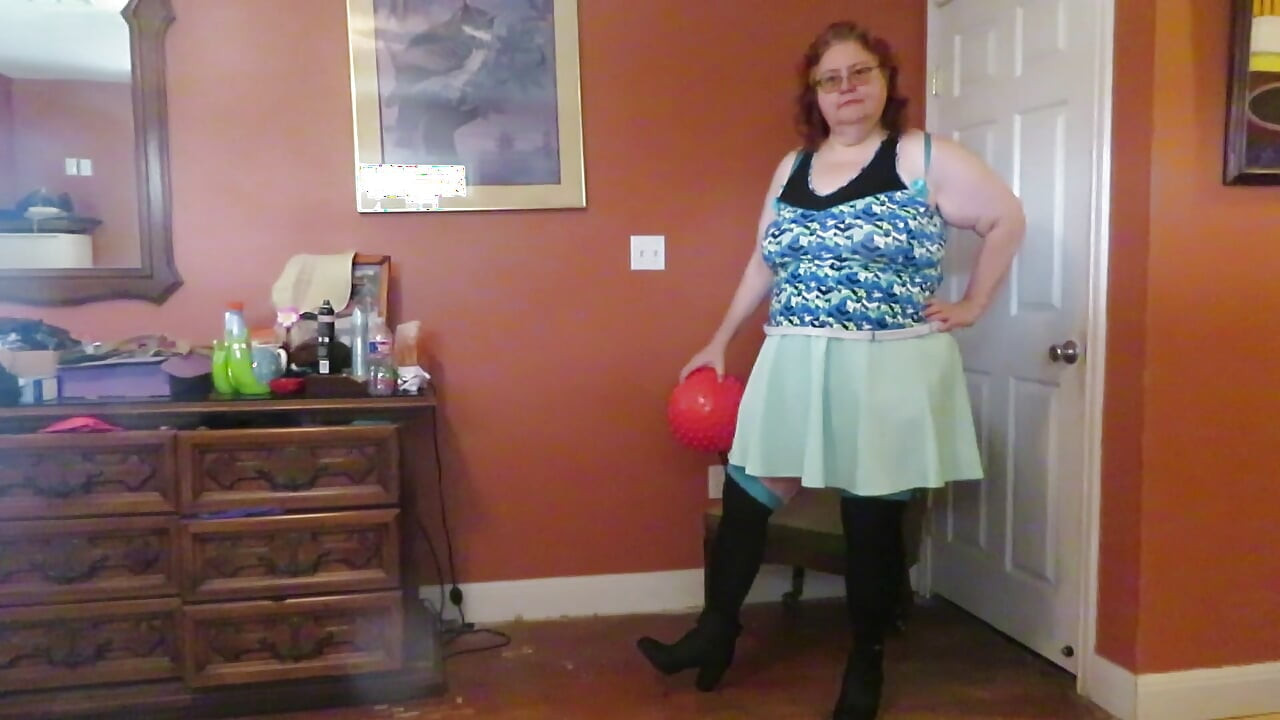 Nurse Vicki  plays with a rubber ball in a mini skirt, sexy stockings and high heel mini boots