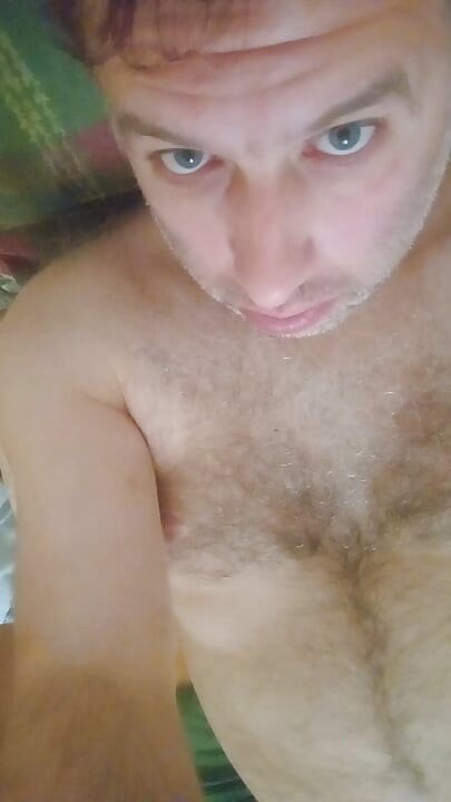 Naked guy lying on the bed jerks off cumming and assessing his cum