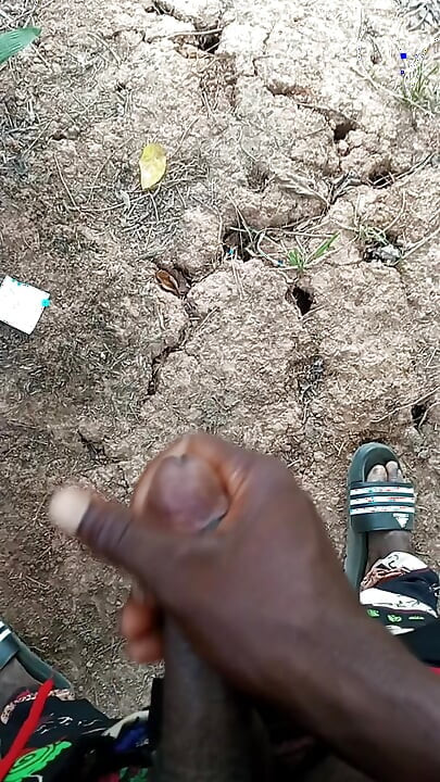 An African adult man masturbating inside the bush with his big dick