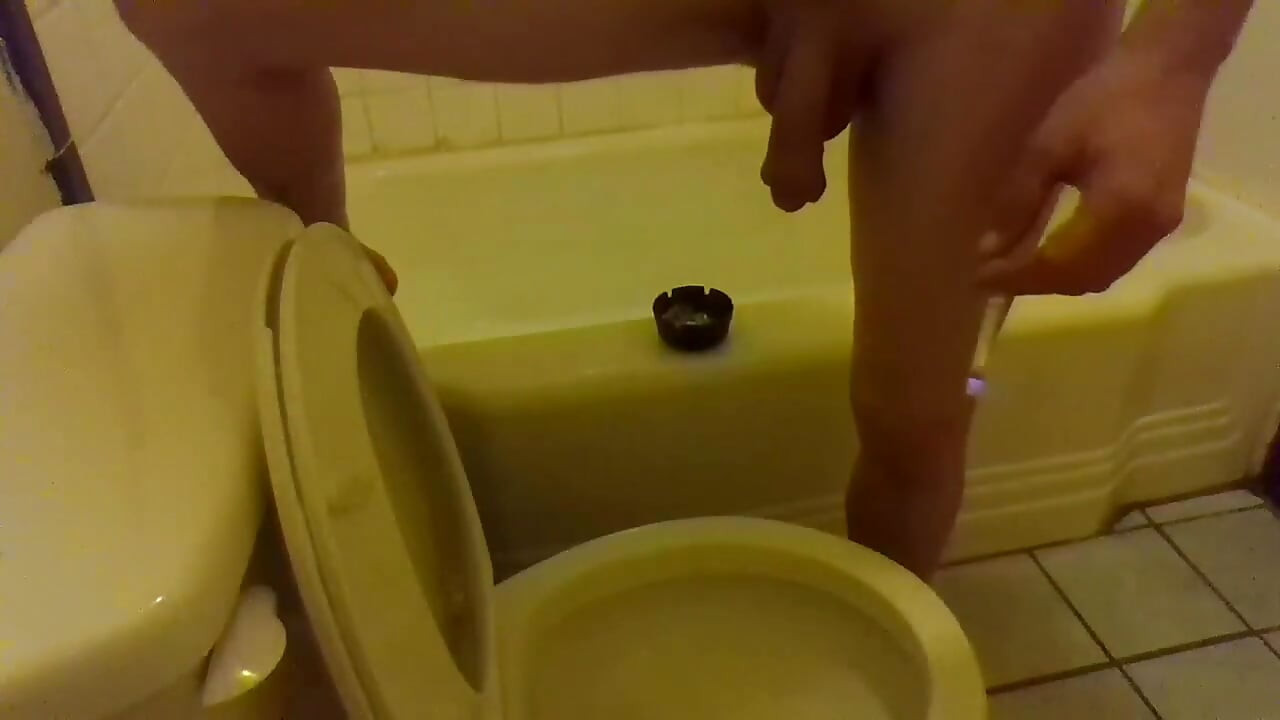 Pissing in the Toilet While Standing on the Bathtub